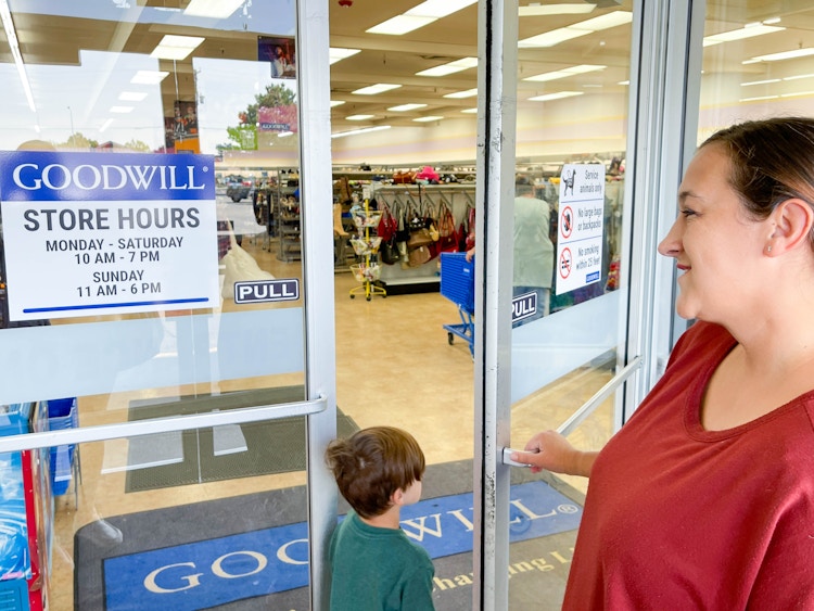 a woman going into entrance of goodwill