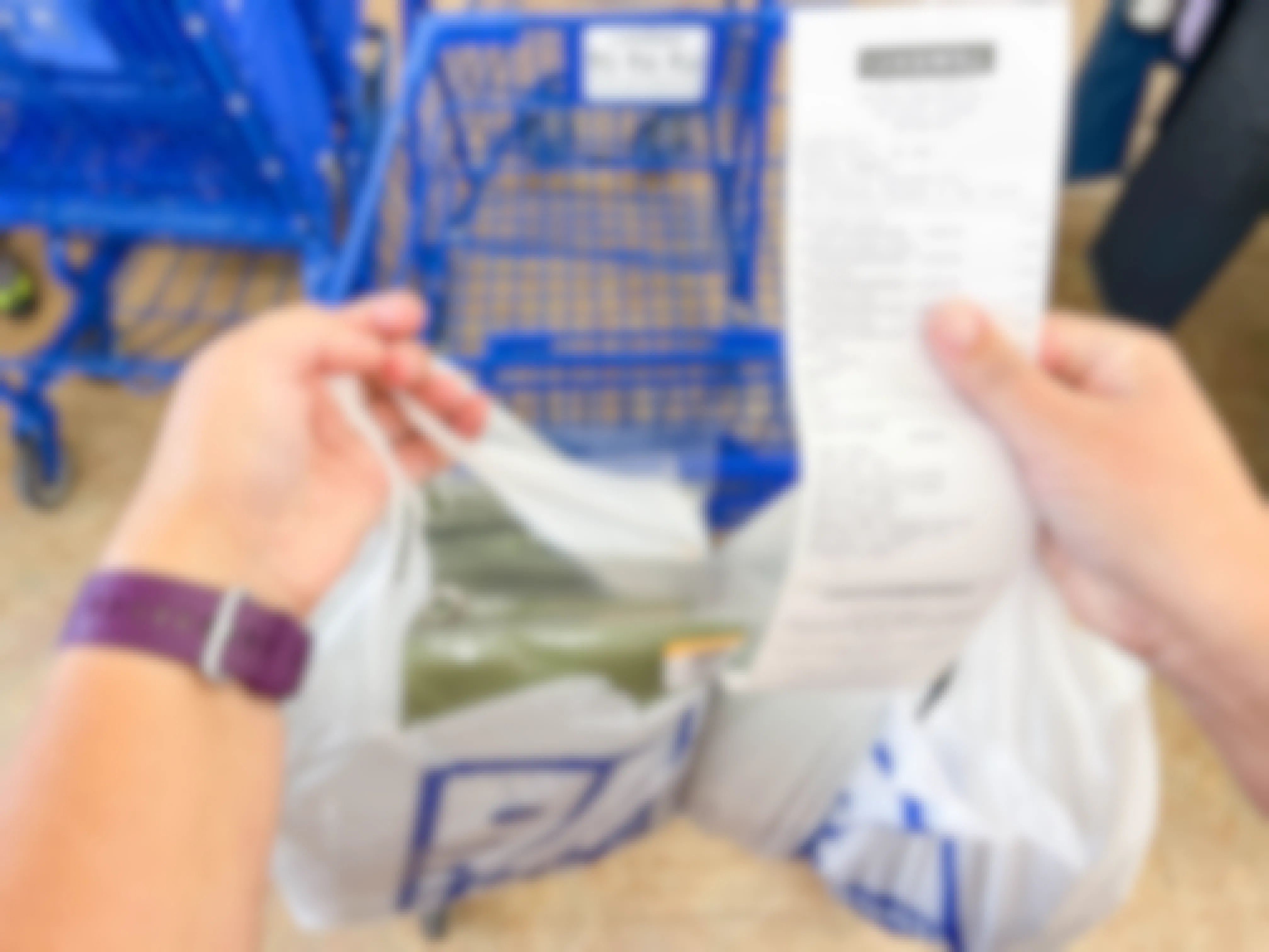 a goodwill receipt being held with shopping bag