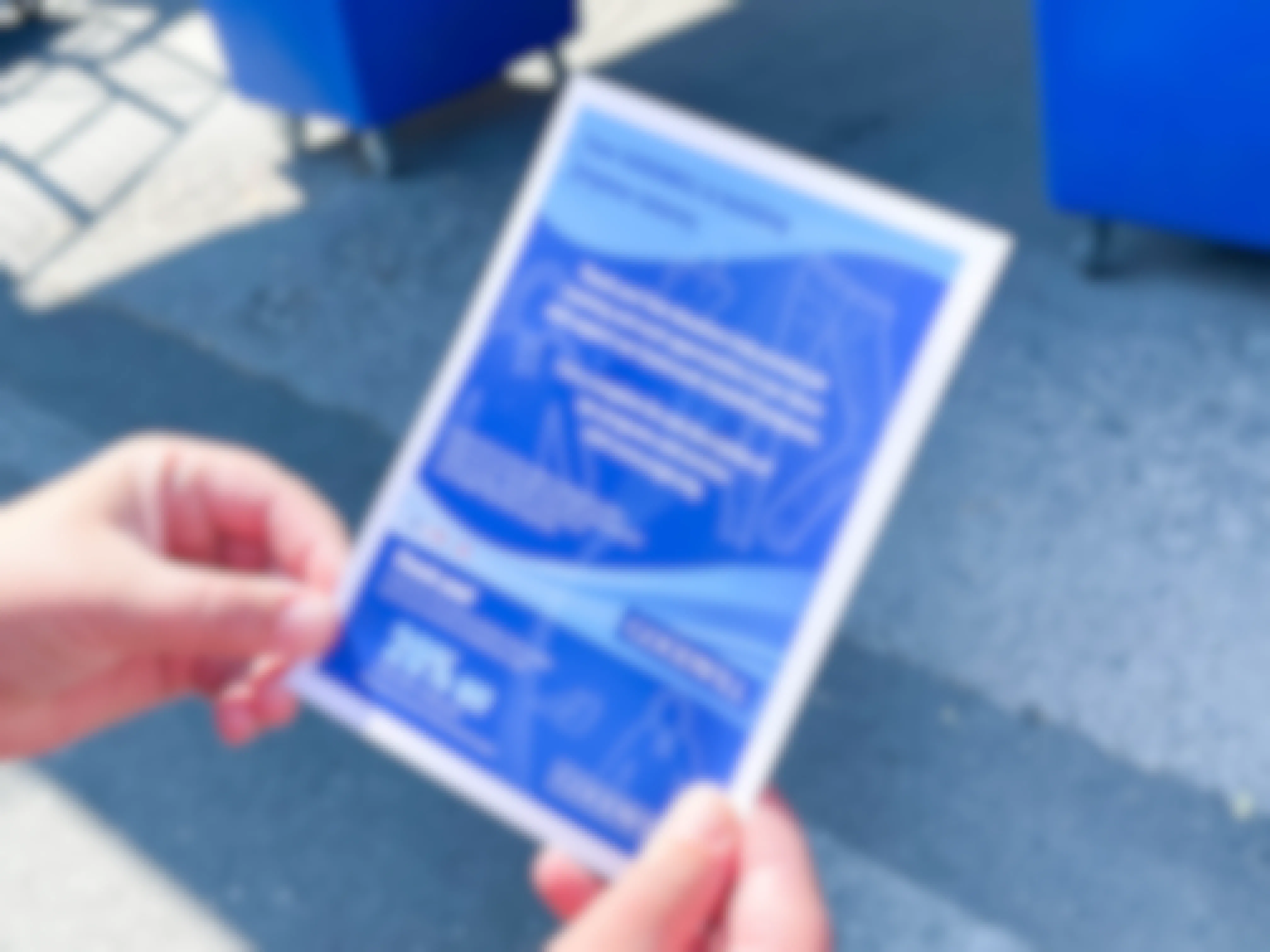 a person holding goodwill donation coupon and tax receipt