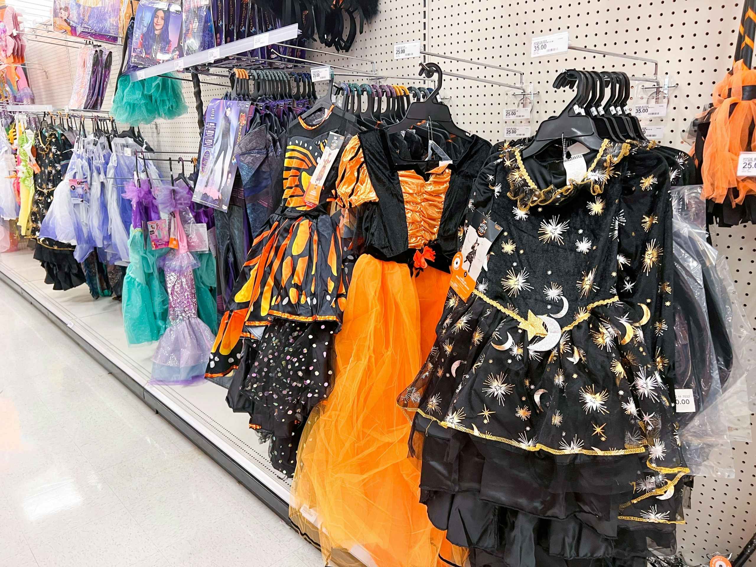 halloween costumes hanging in an aisle