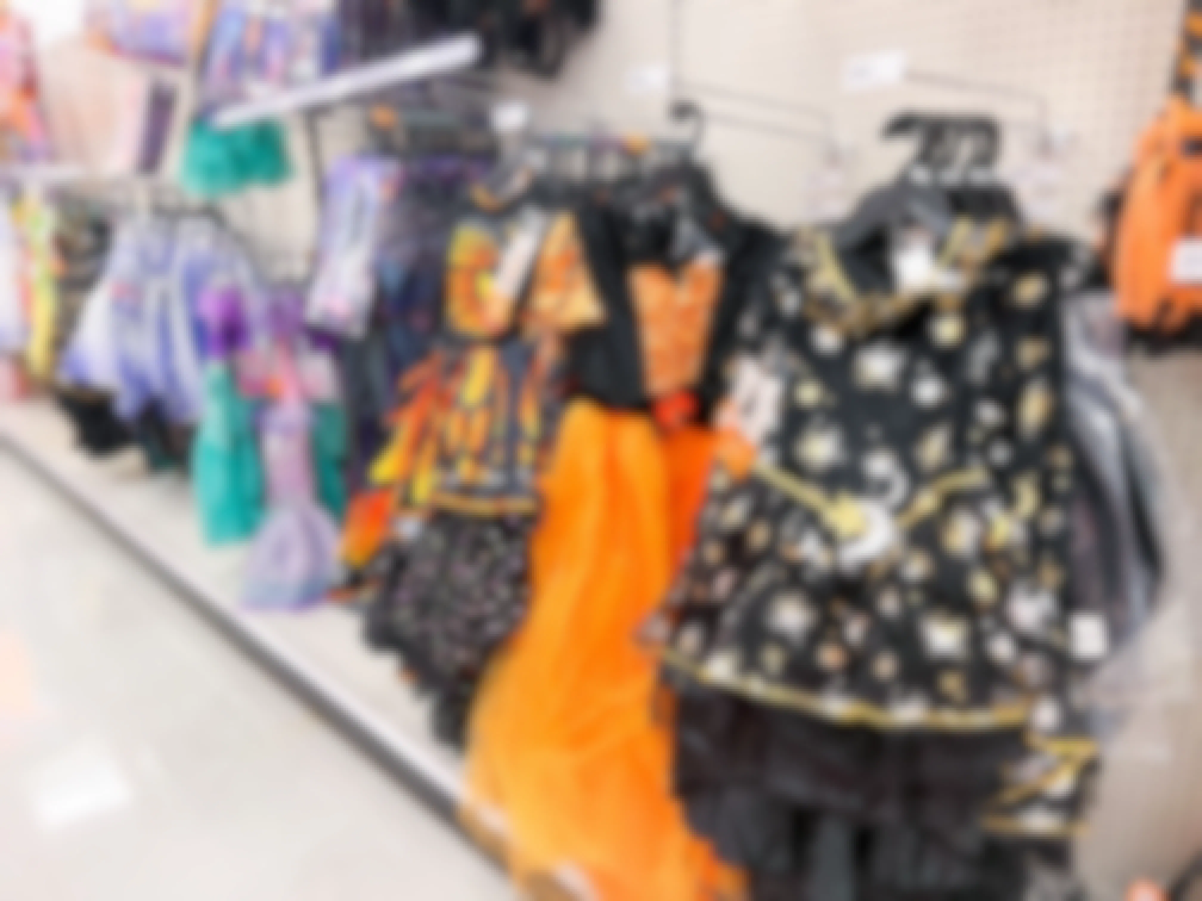 halloween costumes hanging in an aisle
