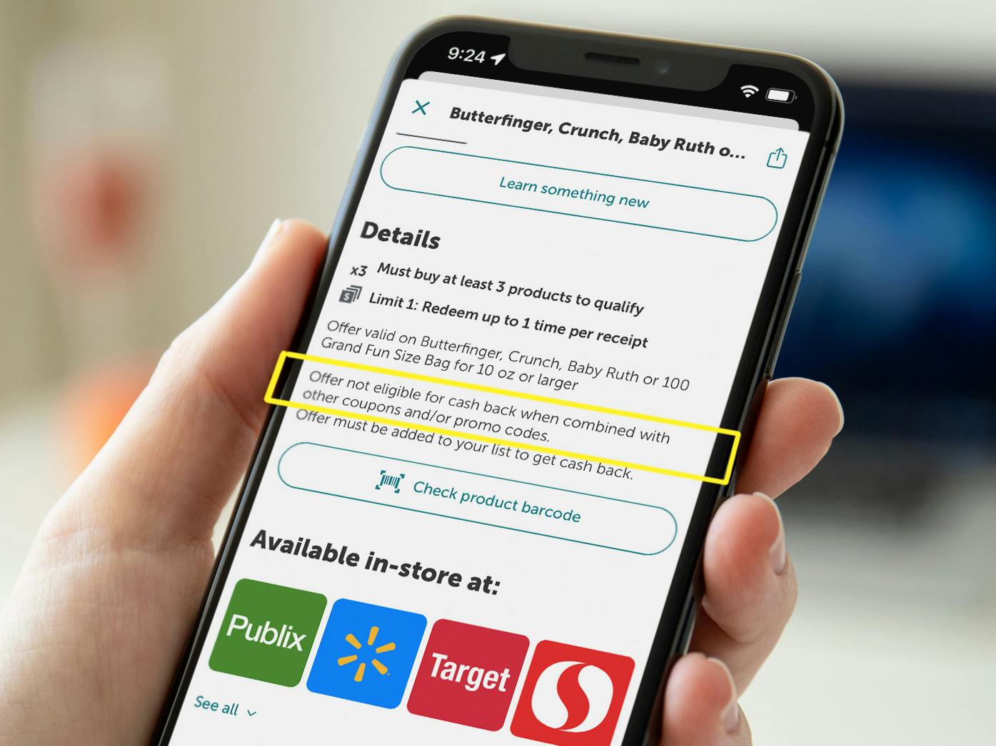 A close up on an offer in the ibotta app displayed on a cellphone with a yellow box around text that reads, "Offer not eligible for cash back when combined with other coupons and/or promo codes