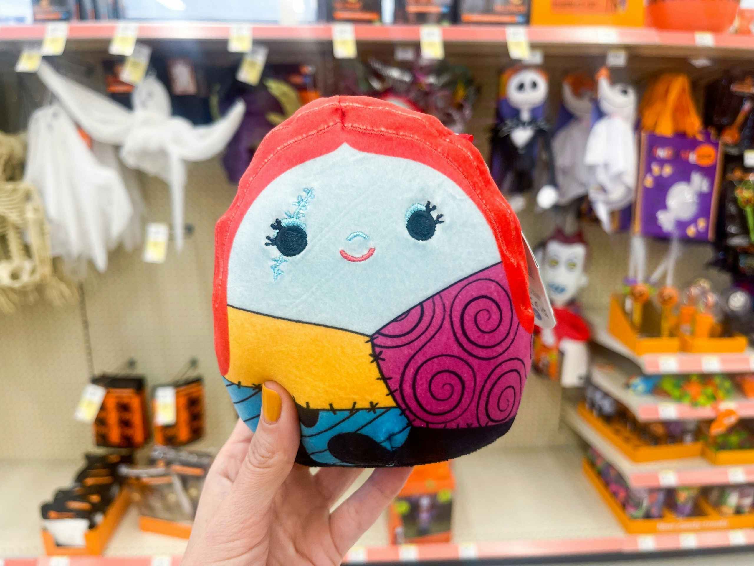 hand holding halloween squishmallow