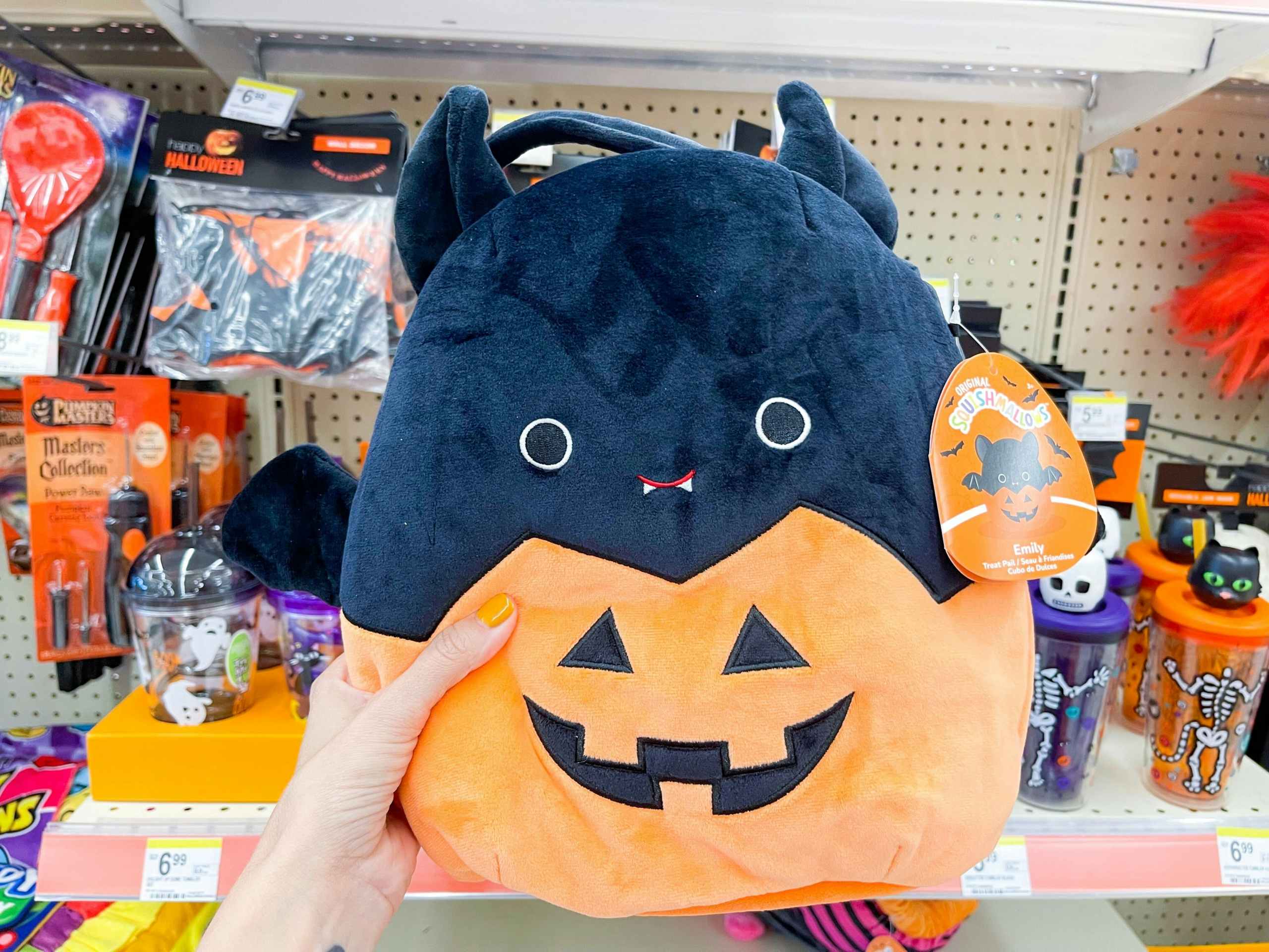 hand holding halloween squishmallow
