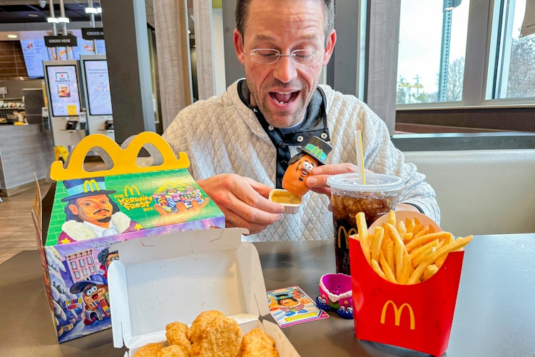 a person holding up a happy meal toy at mcdonalds