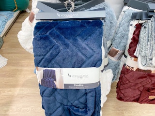 Blue Koolaburra bedding hanging on a rack