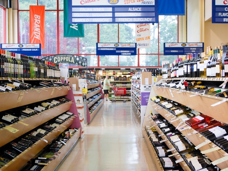 A person shopping in a liquor store.