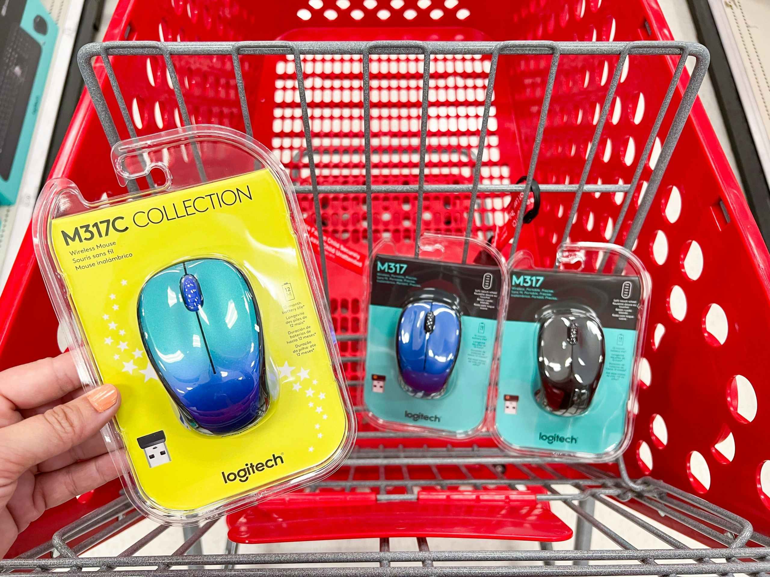 hand holding logitech mouse in front of cart with mice inside