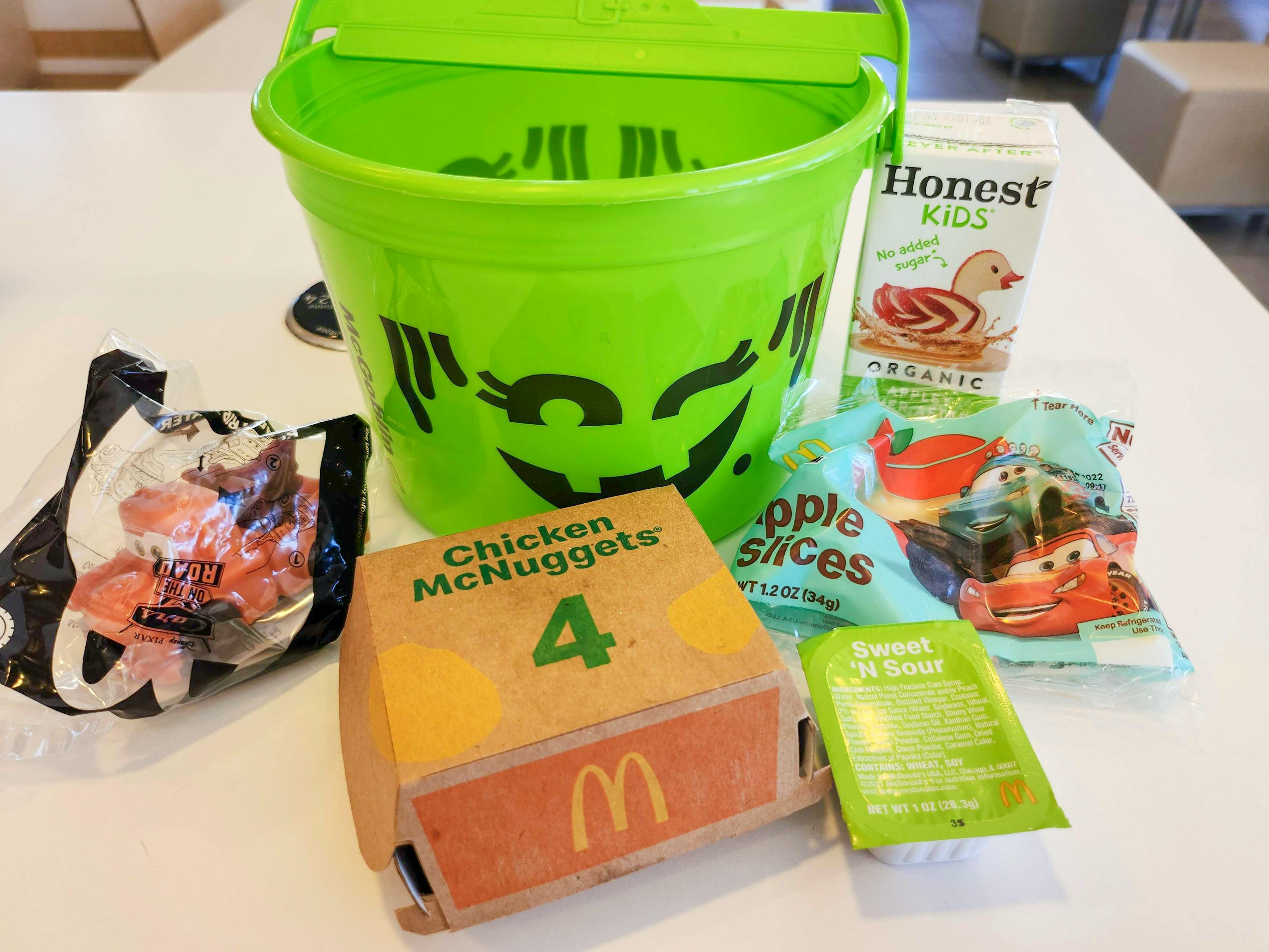 A green McDonalds happy meal Halloween pail with food