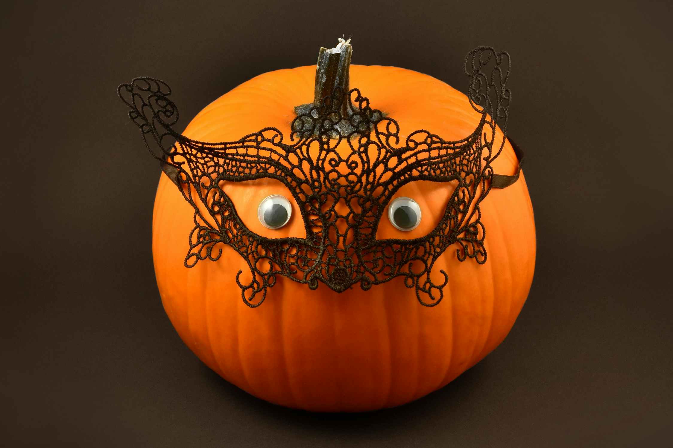 no-carve pumpkin with lace masquerade mask and eyes