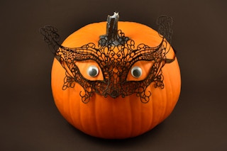 no-carve pumpkin with lace masquerade mask and eyes