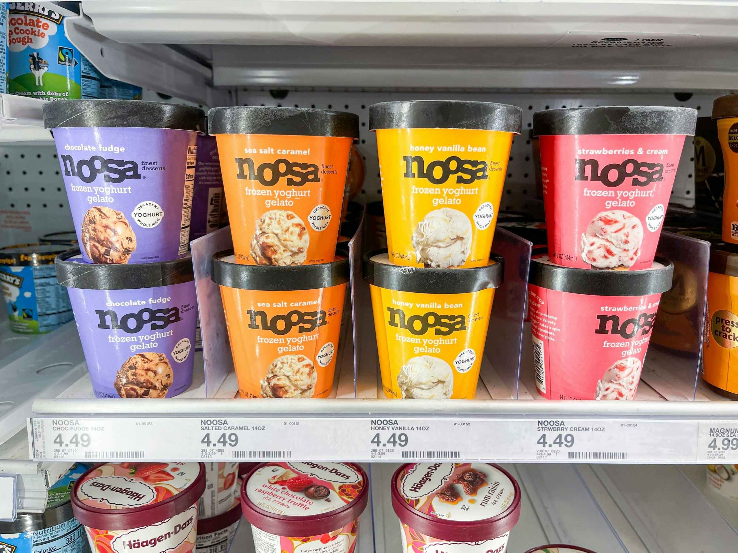 Several pints of Noosa Frozen Yoghurt Gelato sitting in a shelf in a freezer.