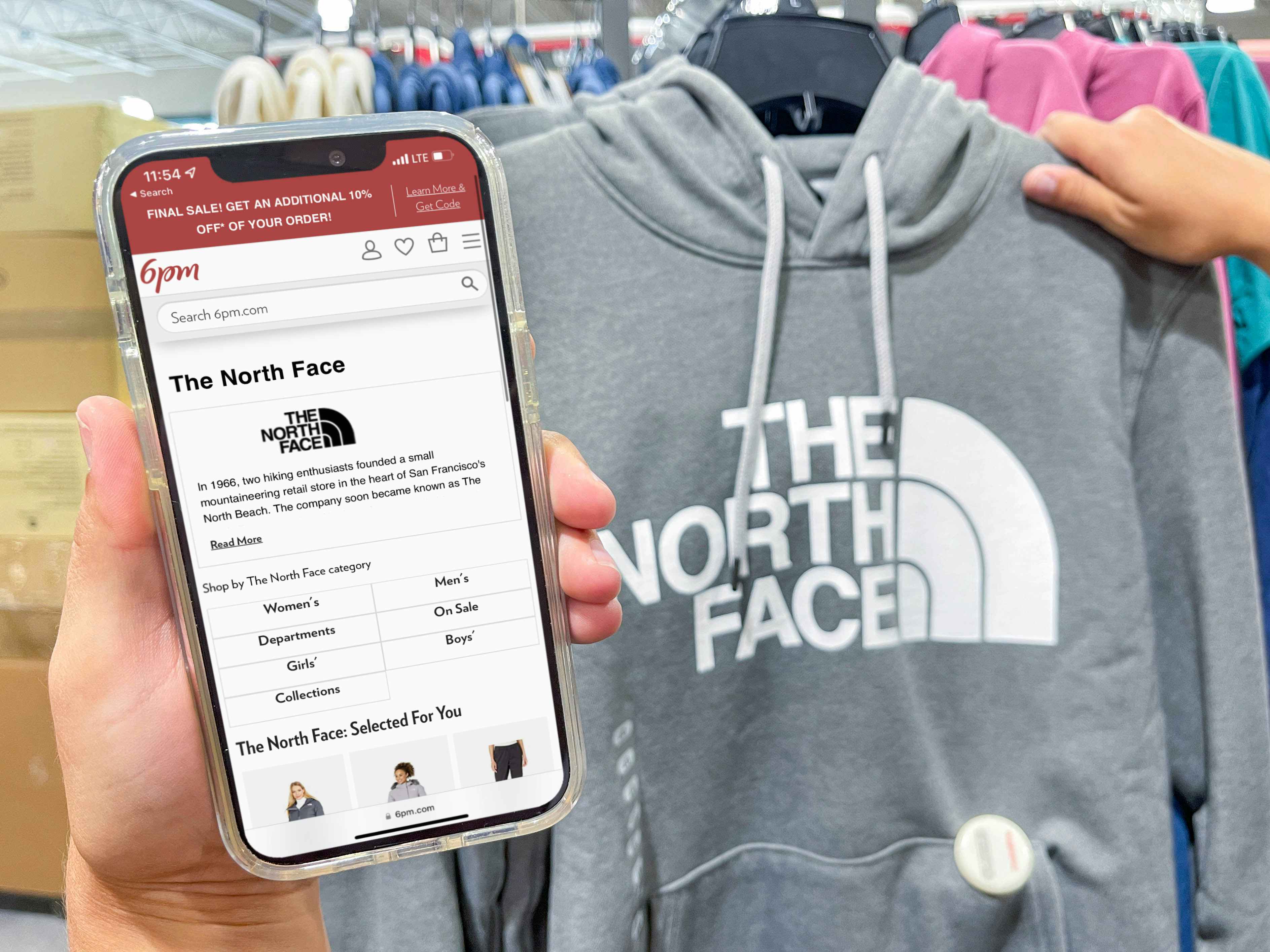 north face on 6 pm app on cellphone screen in front of north face sweatshirt