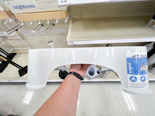 hand holding a squatty potty original bathroom stool at target