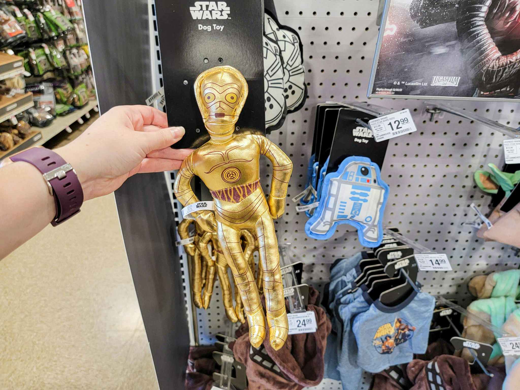 hand holding a gold c3po dog toy