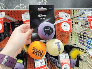 hand holding a pack of 3 hocus pocus cat toy balls