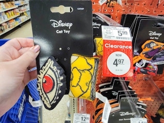 hand holding a 2-pack of hocus pocus cat toys