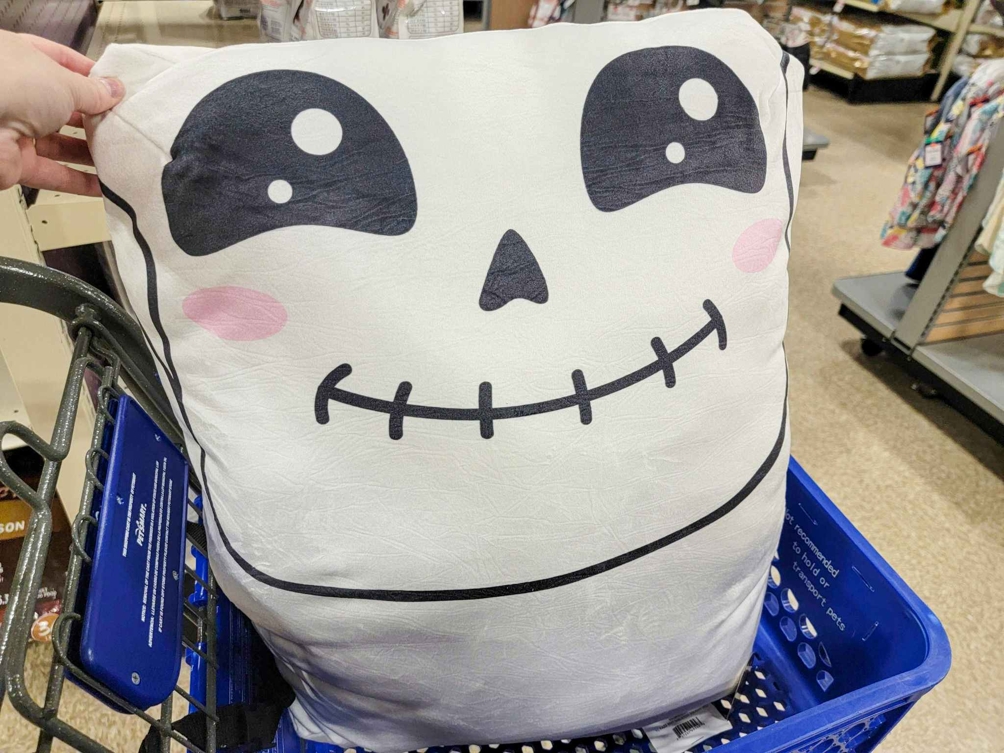 a smiling skeleton pet bed in a cart