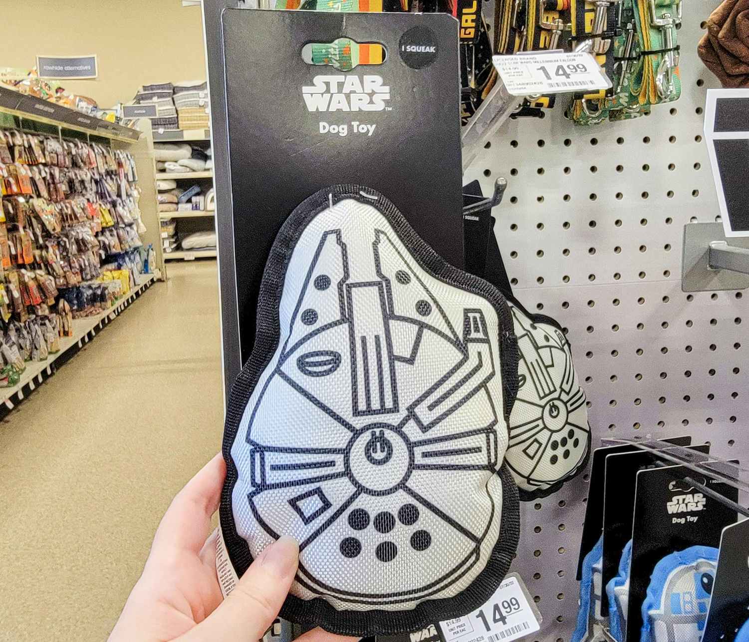 hand holding a millennium falcon dog toy