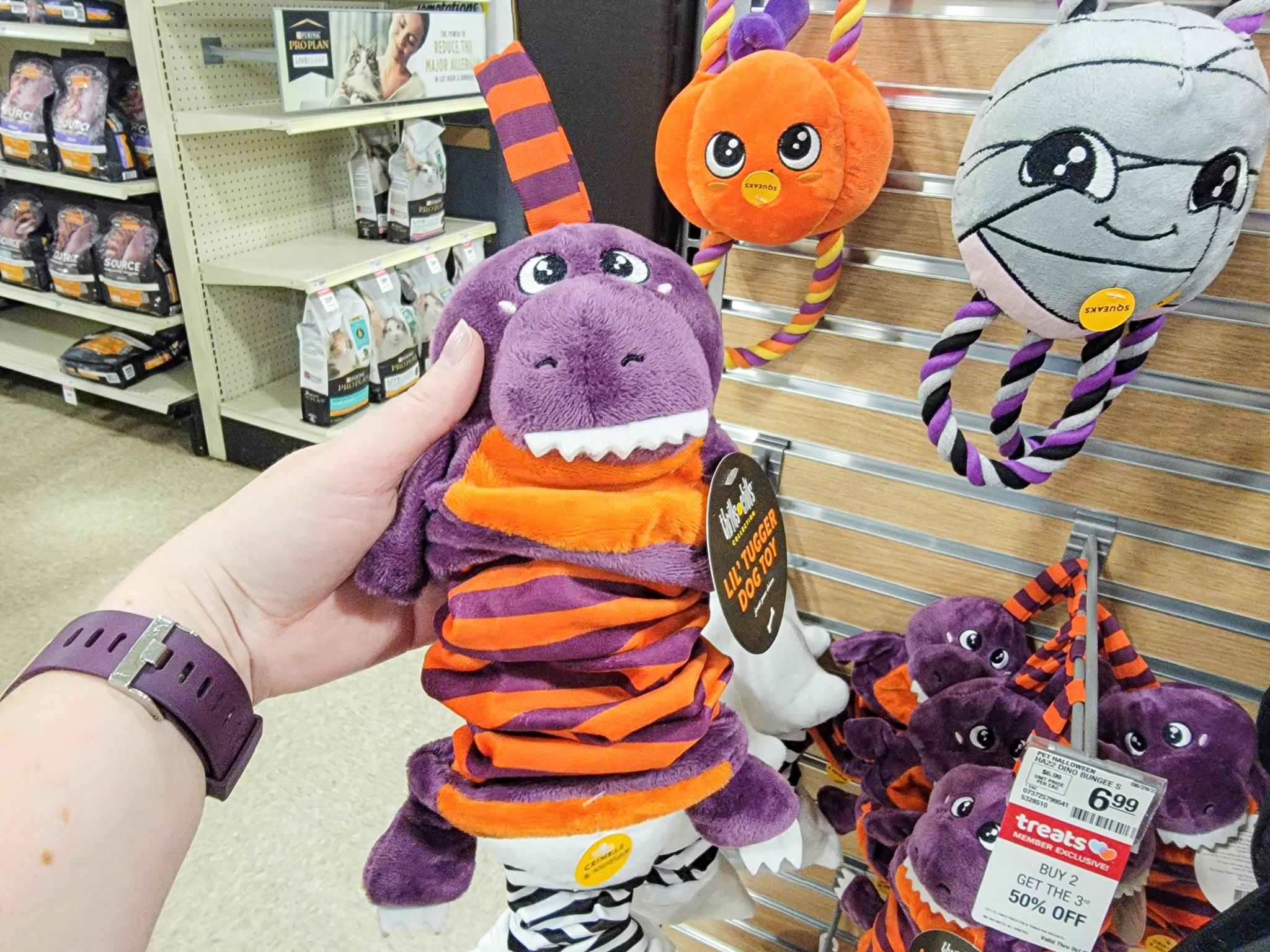 a purple dinosaur tug dog toy