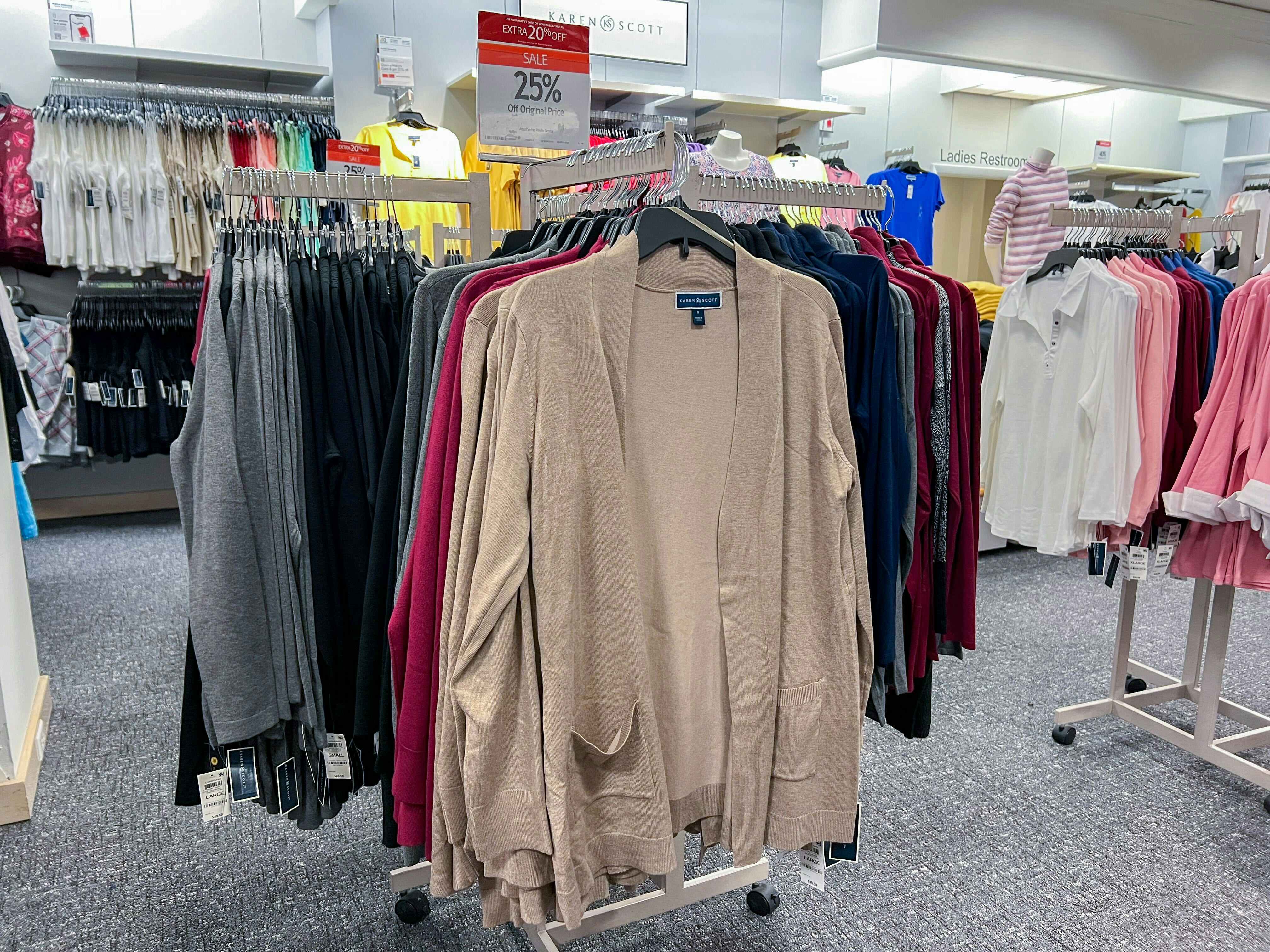 plus-size sweater cardigans hanging on a rack