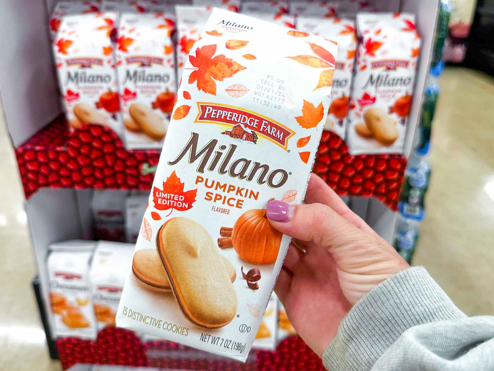 someone holding a bag of pumpkin spice Milano cookies