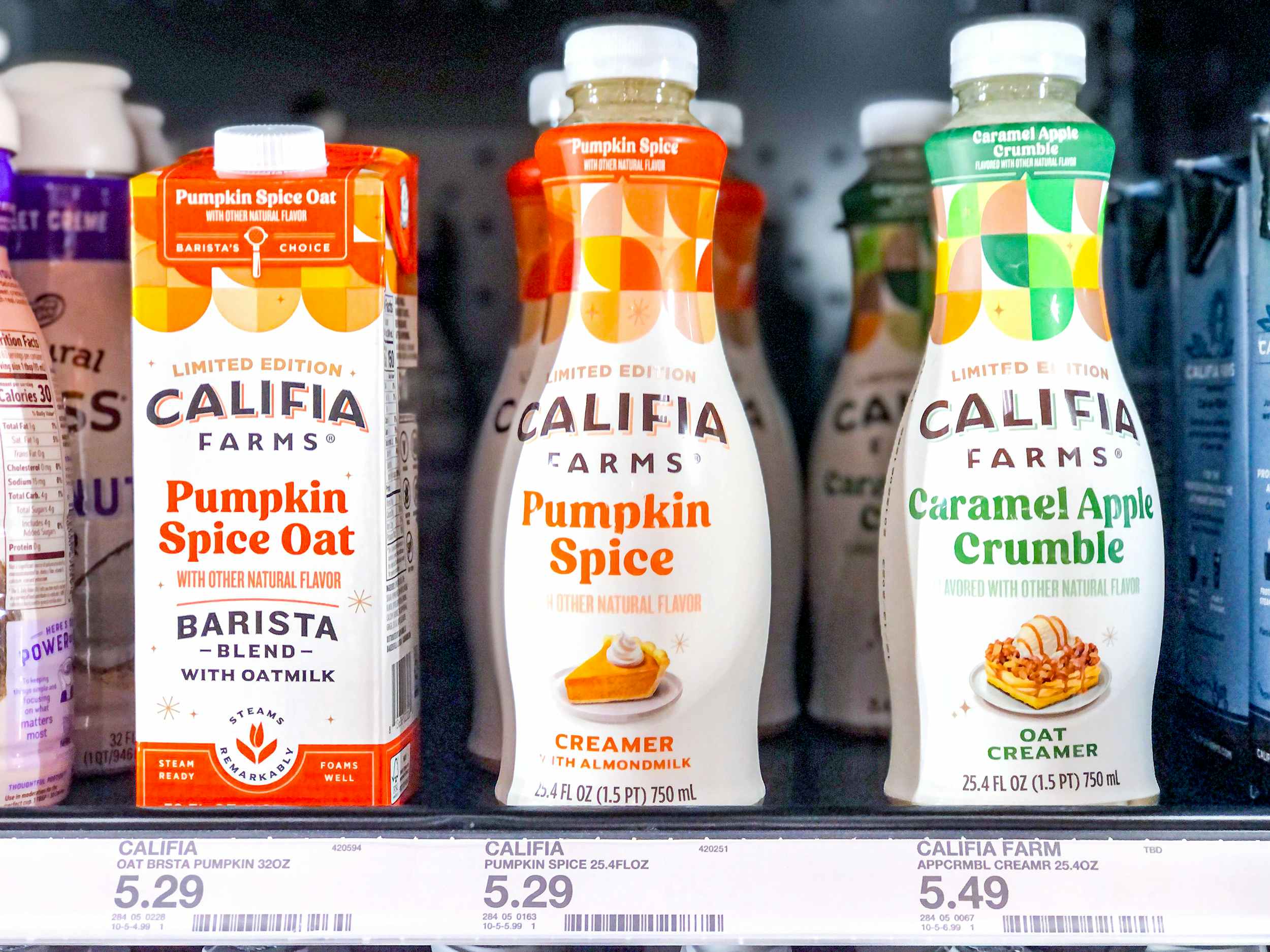 califia farms pumpkin spice oat milk and caramel apple crumble coffee creamer in store refrigerator