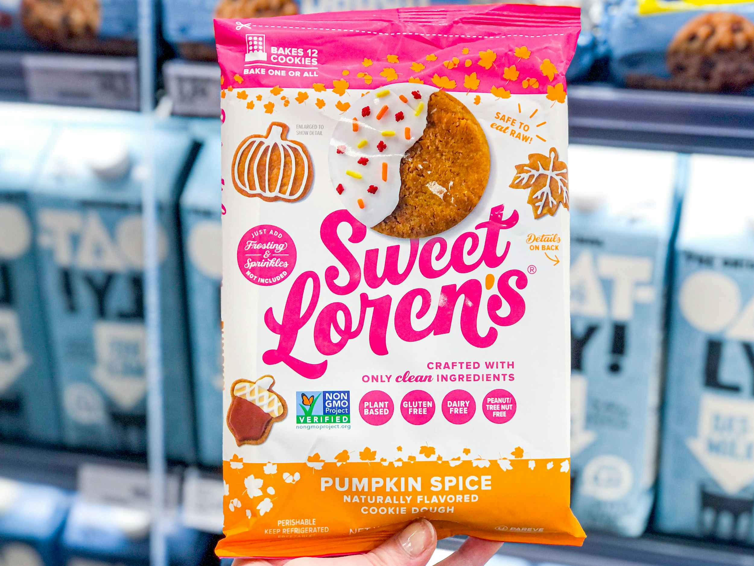 hand holding sweet lorens refrigerated pumpkin spice cookie dough in store aisle in store