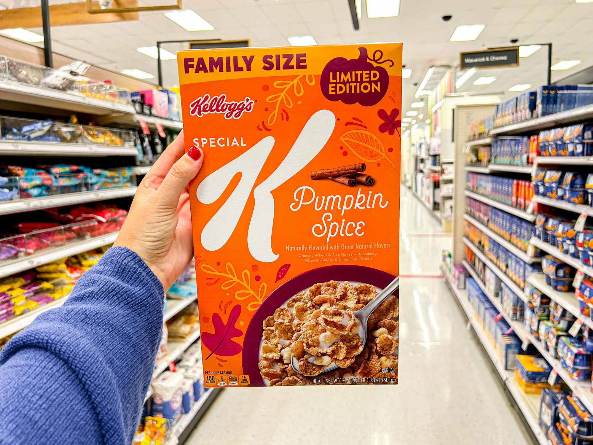 a person holding up pumpkin spice special k in target