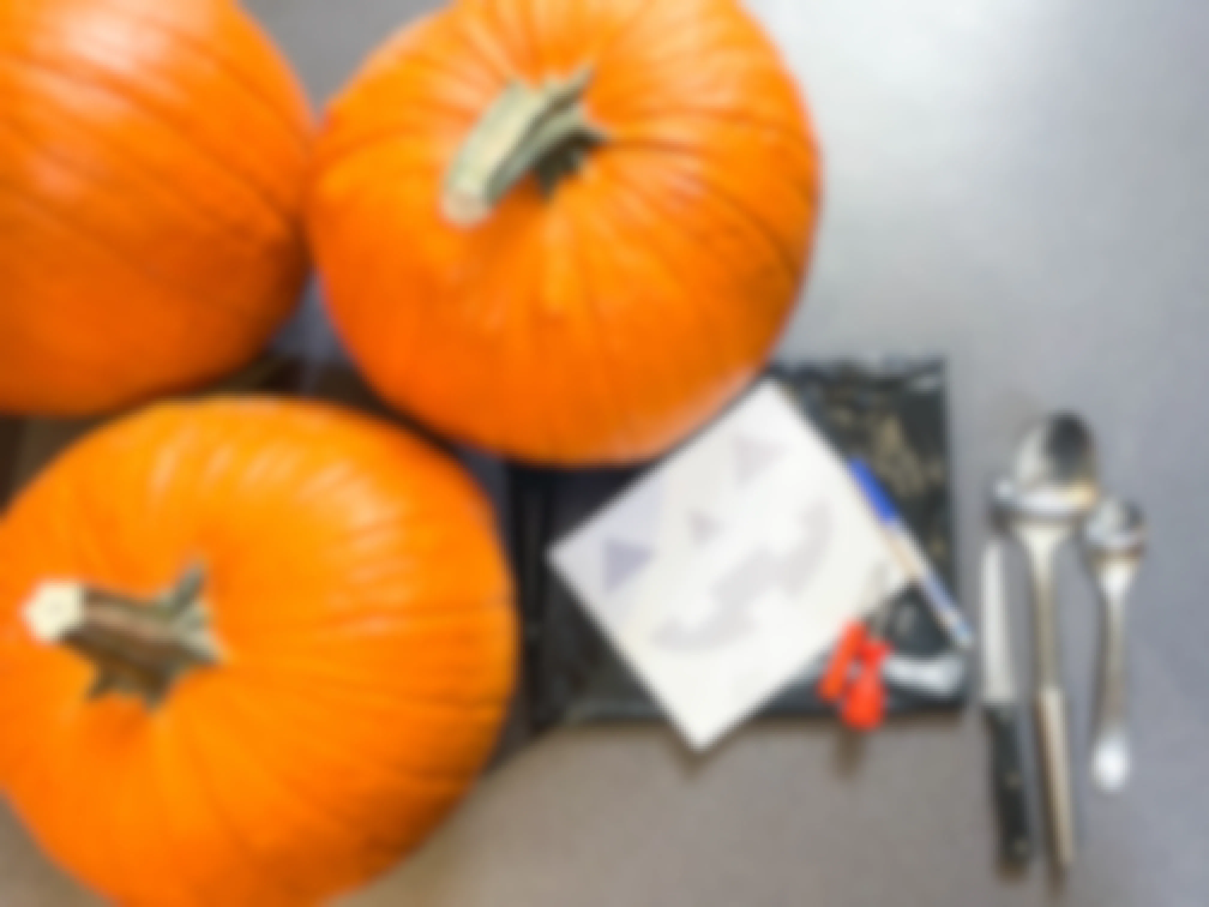 supplies to carve a face in a pumpkin on a countertop