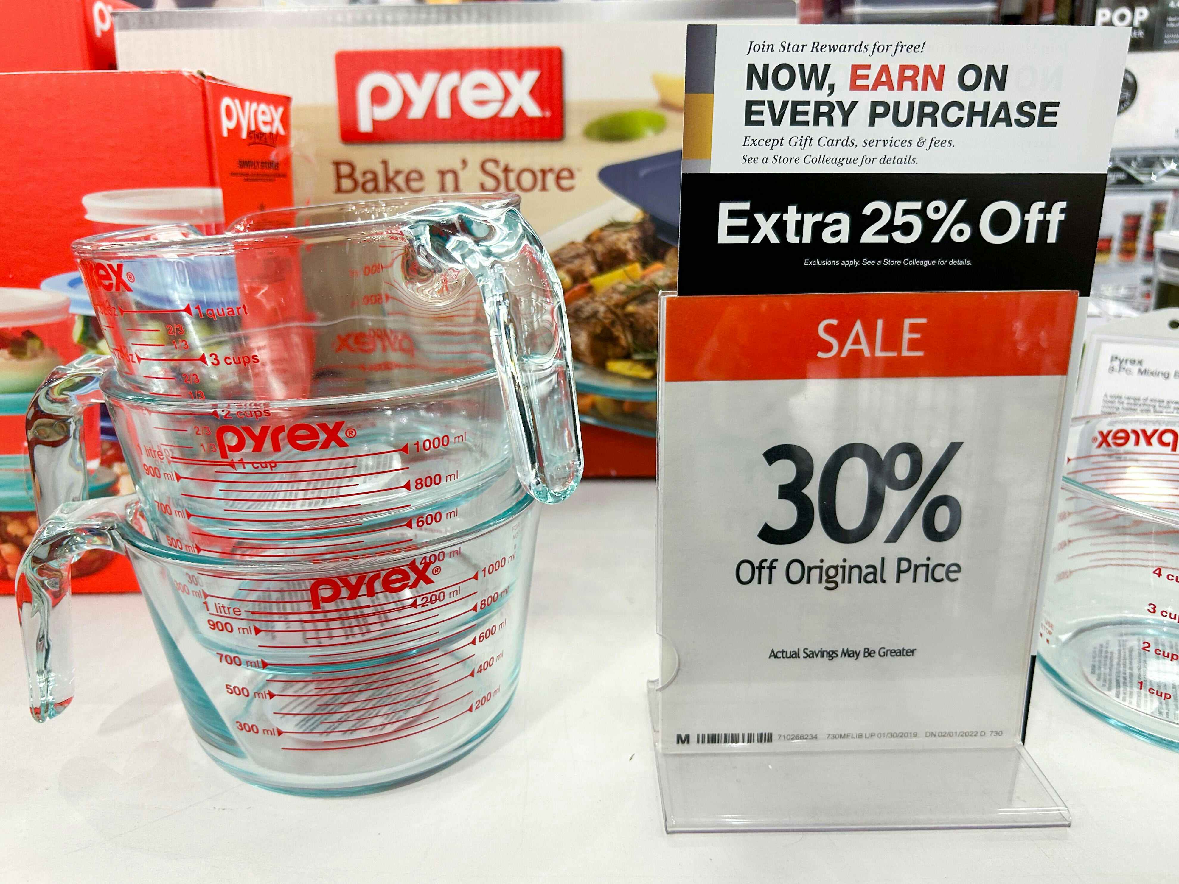 a pyrex measuring cup by a sale sign