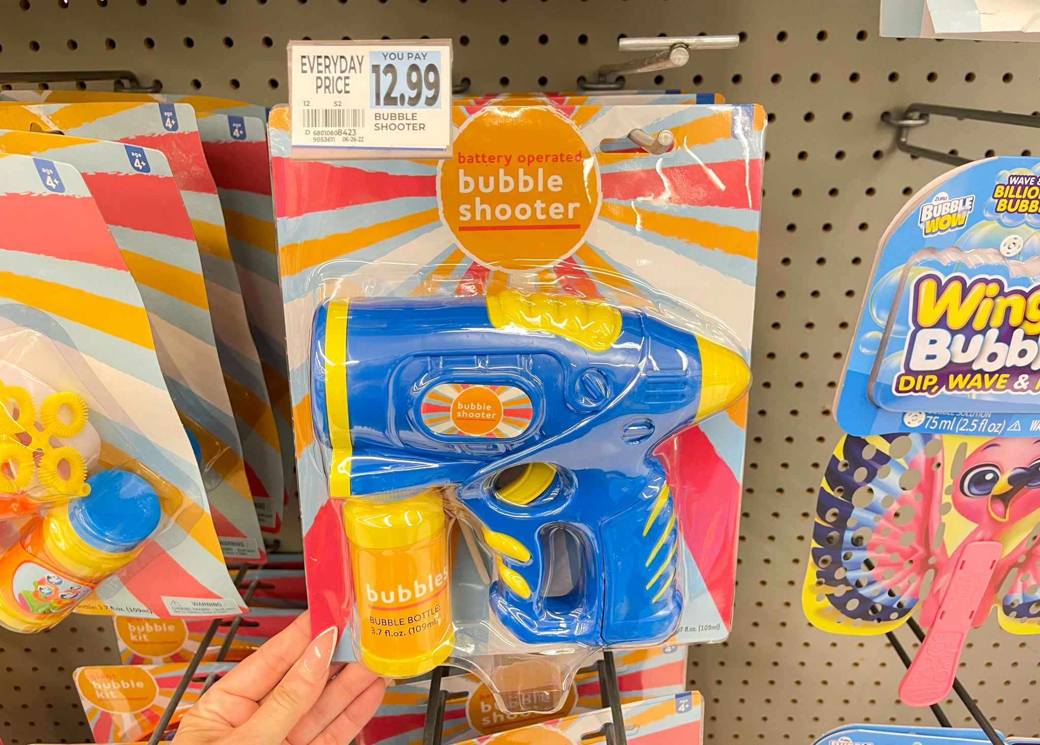 hand holding bubble shooter under price tag