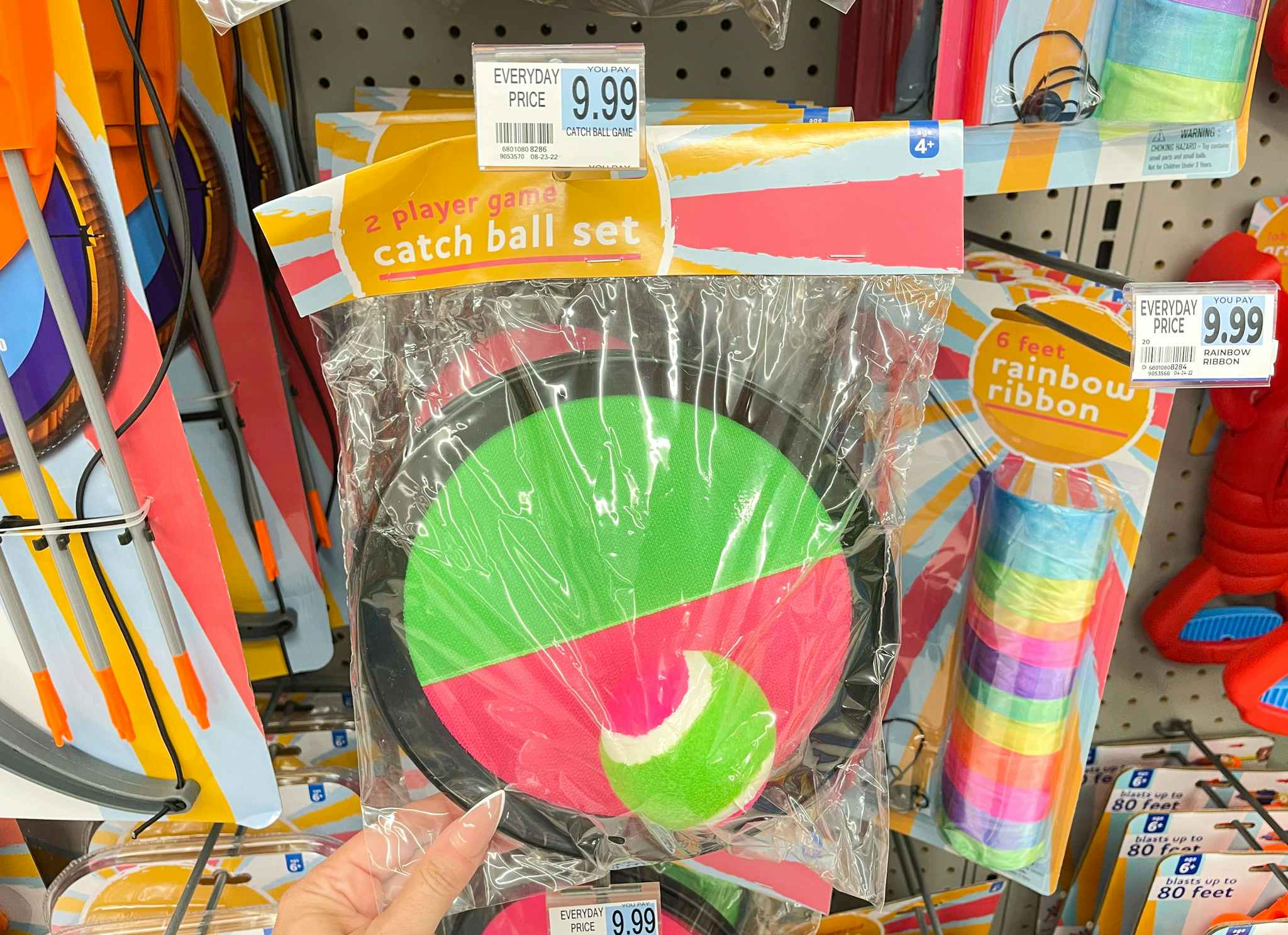 hand holding catch ball set under price tag