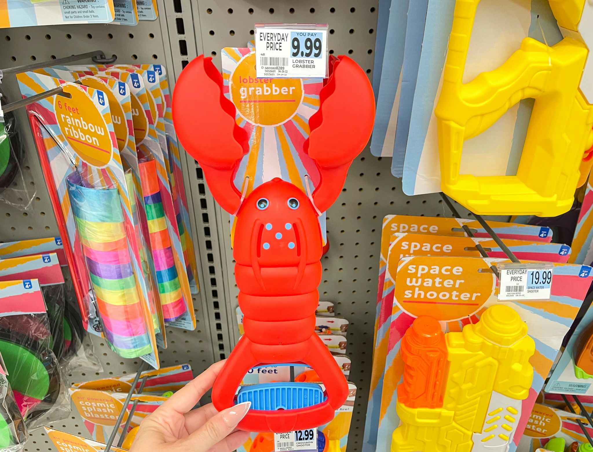 hand holding lobster claw under price tag