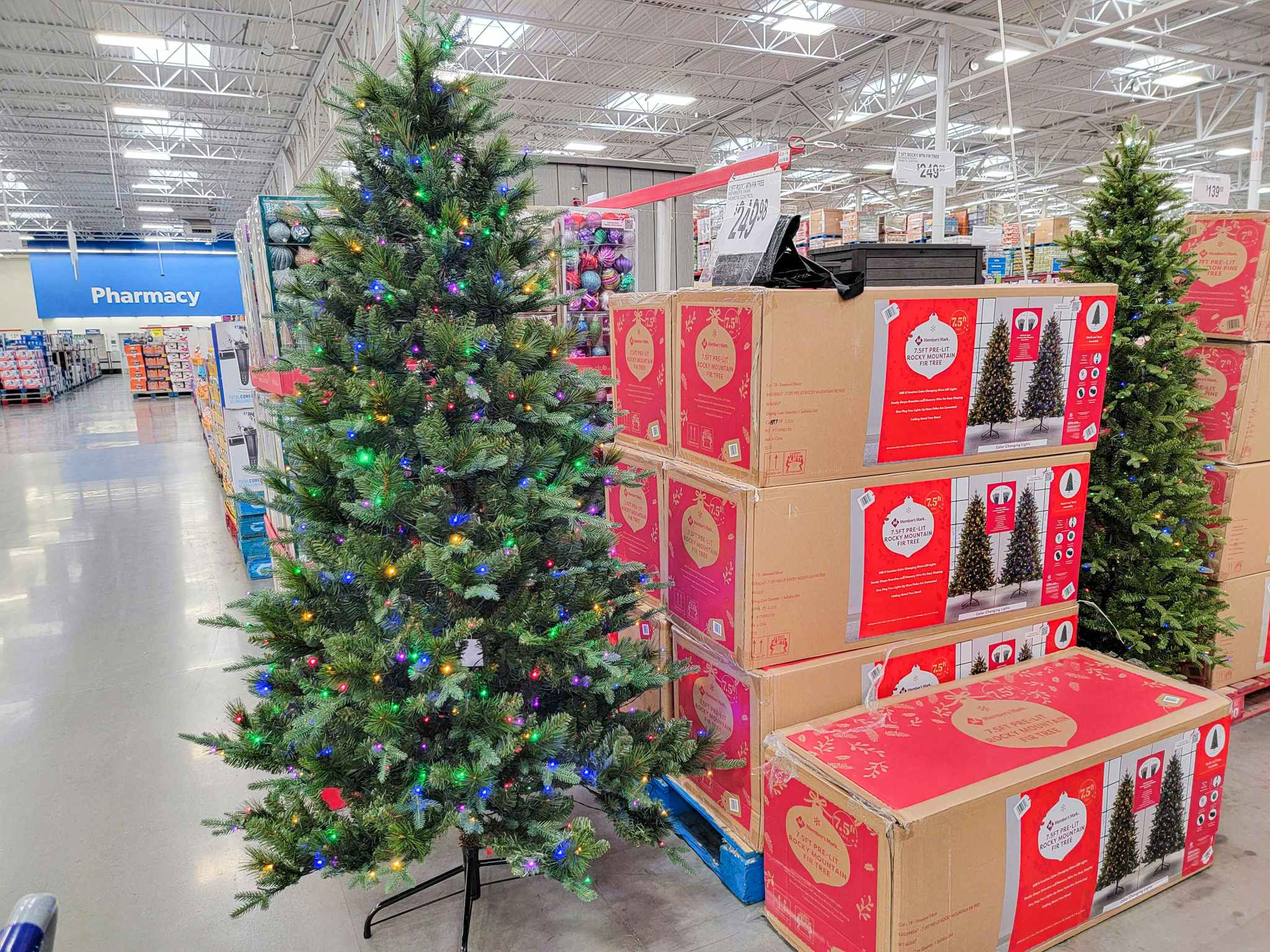 a 7.5 foot prelit christmas tree displayed by boxes of trees