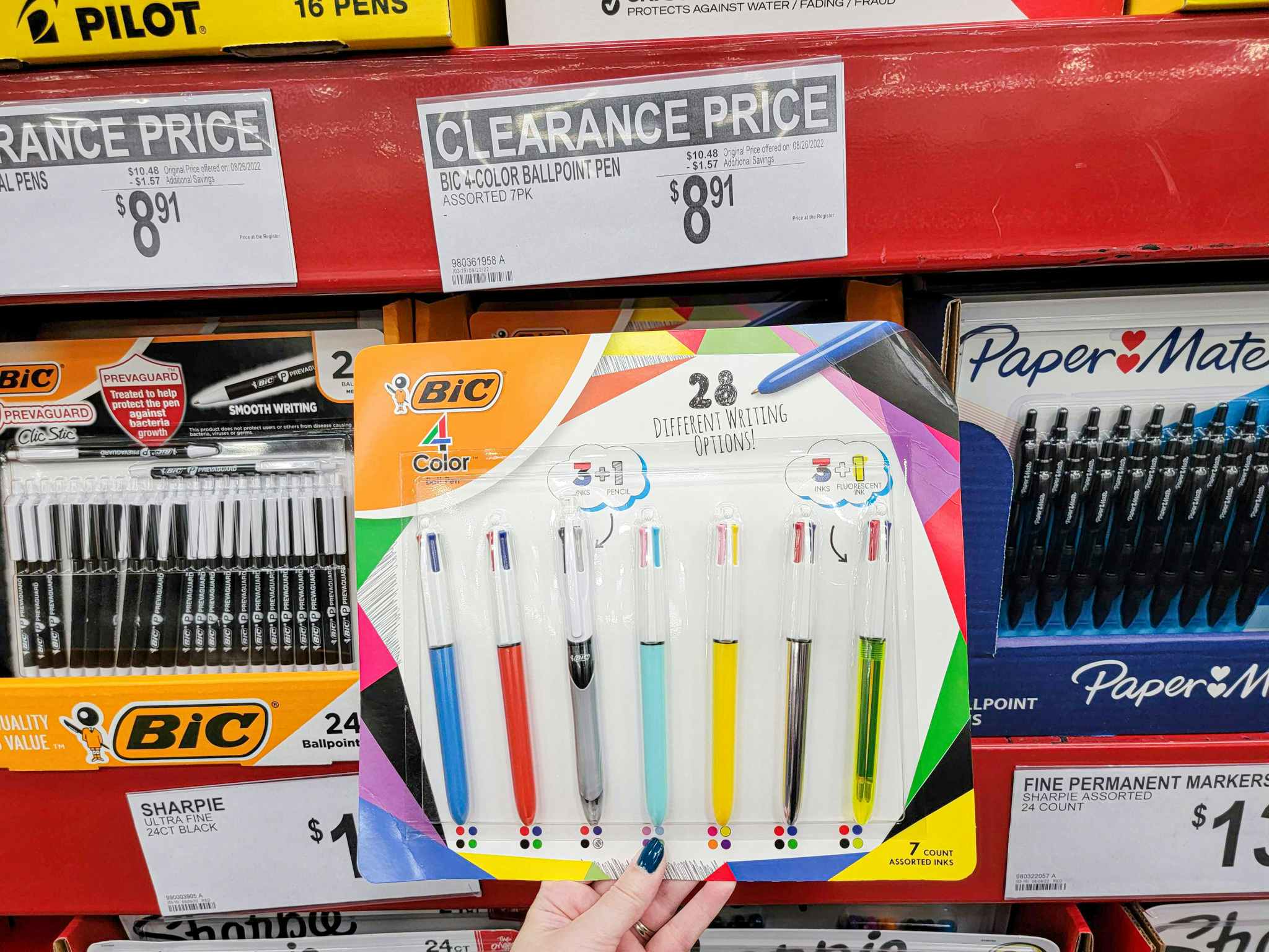 hand holding a 7 pack of bic 4 color pens
