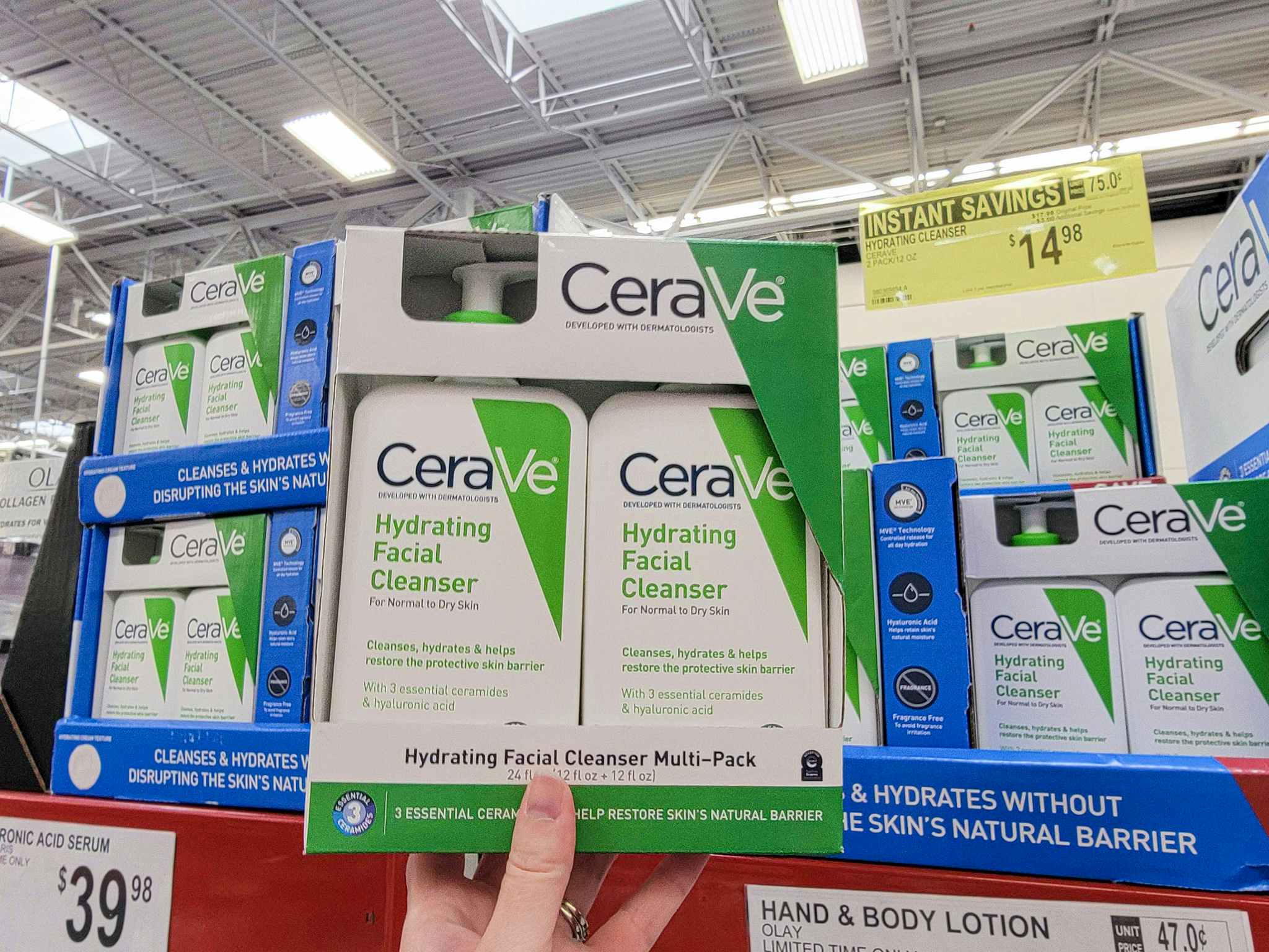 hand holding a 2-pack of cerave hydrating cleanser