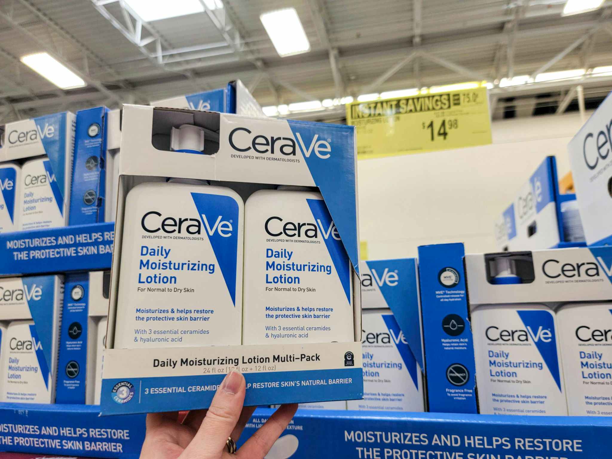 hand holding a 2 pack of cerave moisturizing lotion