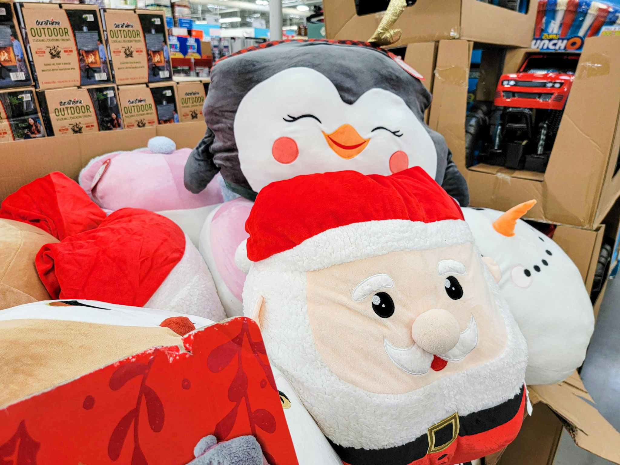 penguin and santa jumbo squishy plushes in a cart