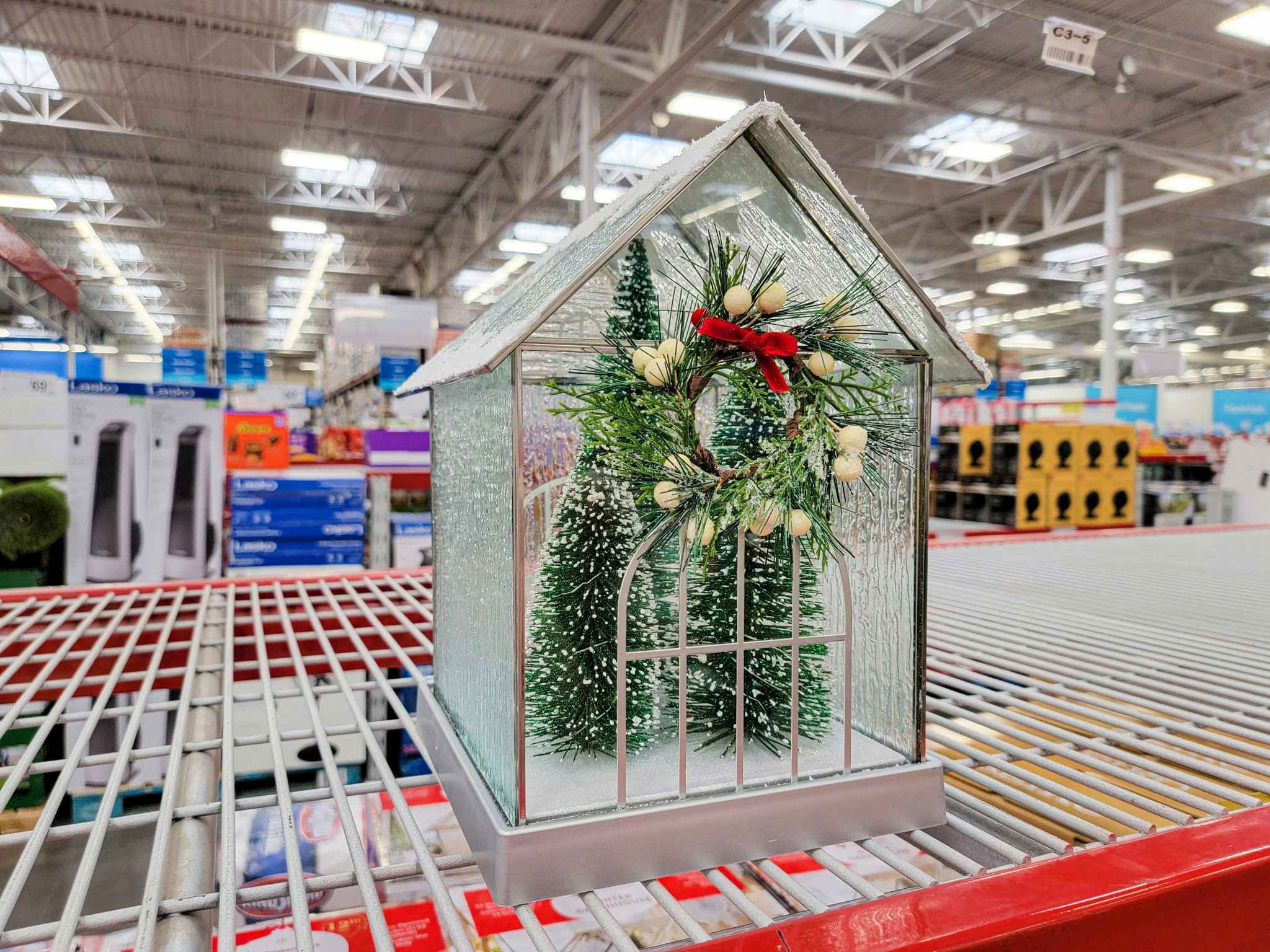 a display of a christmas greenhouse on a shelf