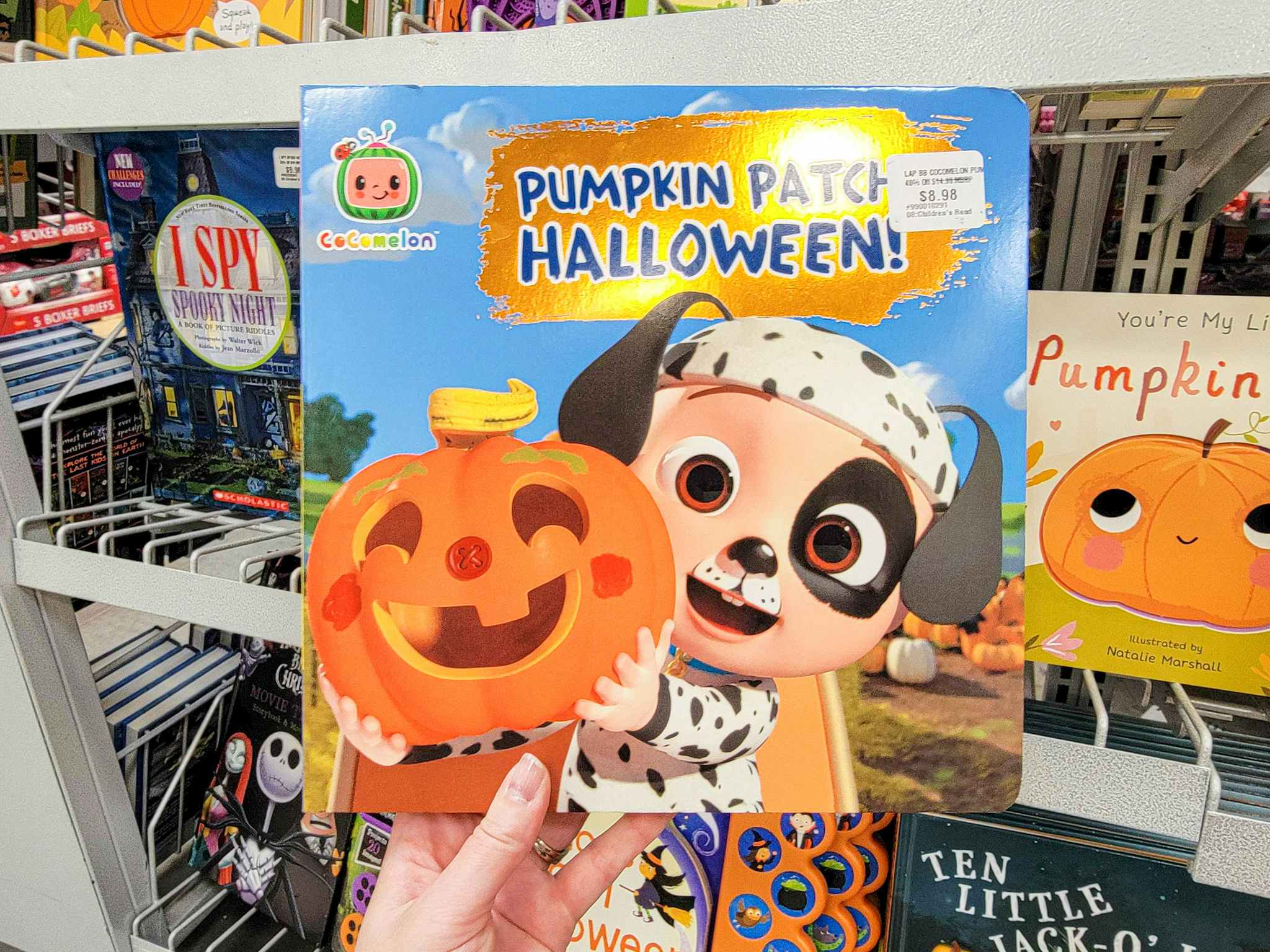 hand holding a kids book, cocomelon pumpkin patch halloween