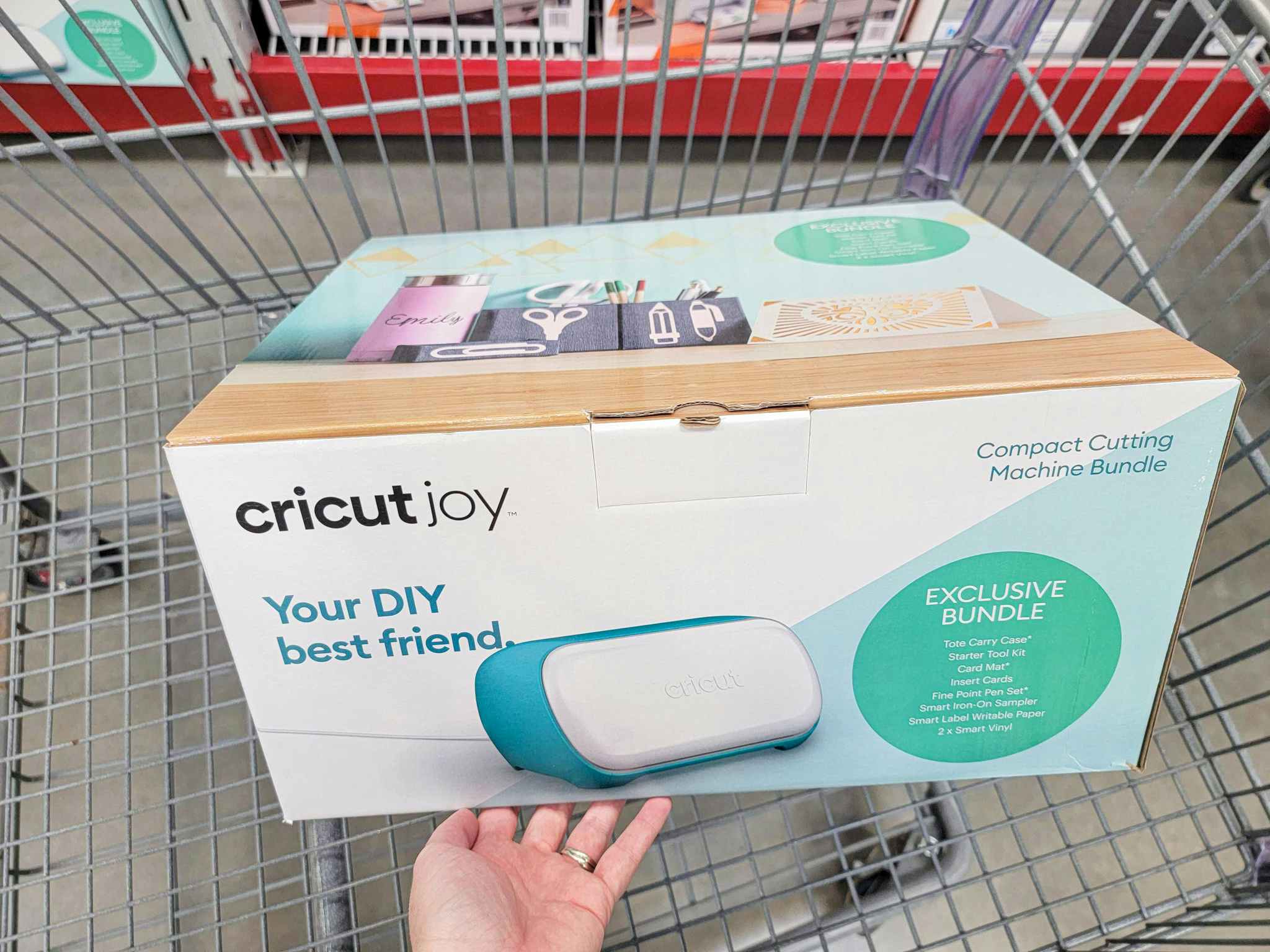 hand holding a cricut joy box in a cart