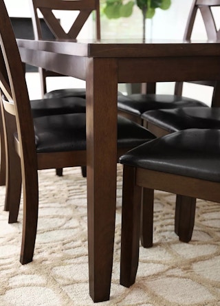 corner of a dining table with chairs