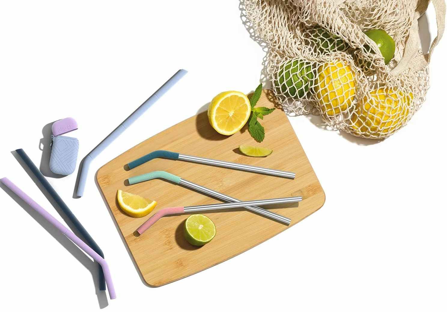 ello reusable straws displayed on a cutting board with lemons