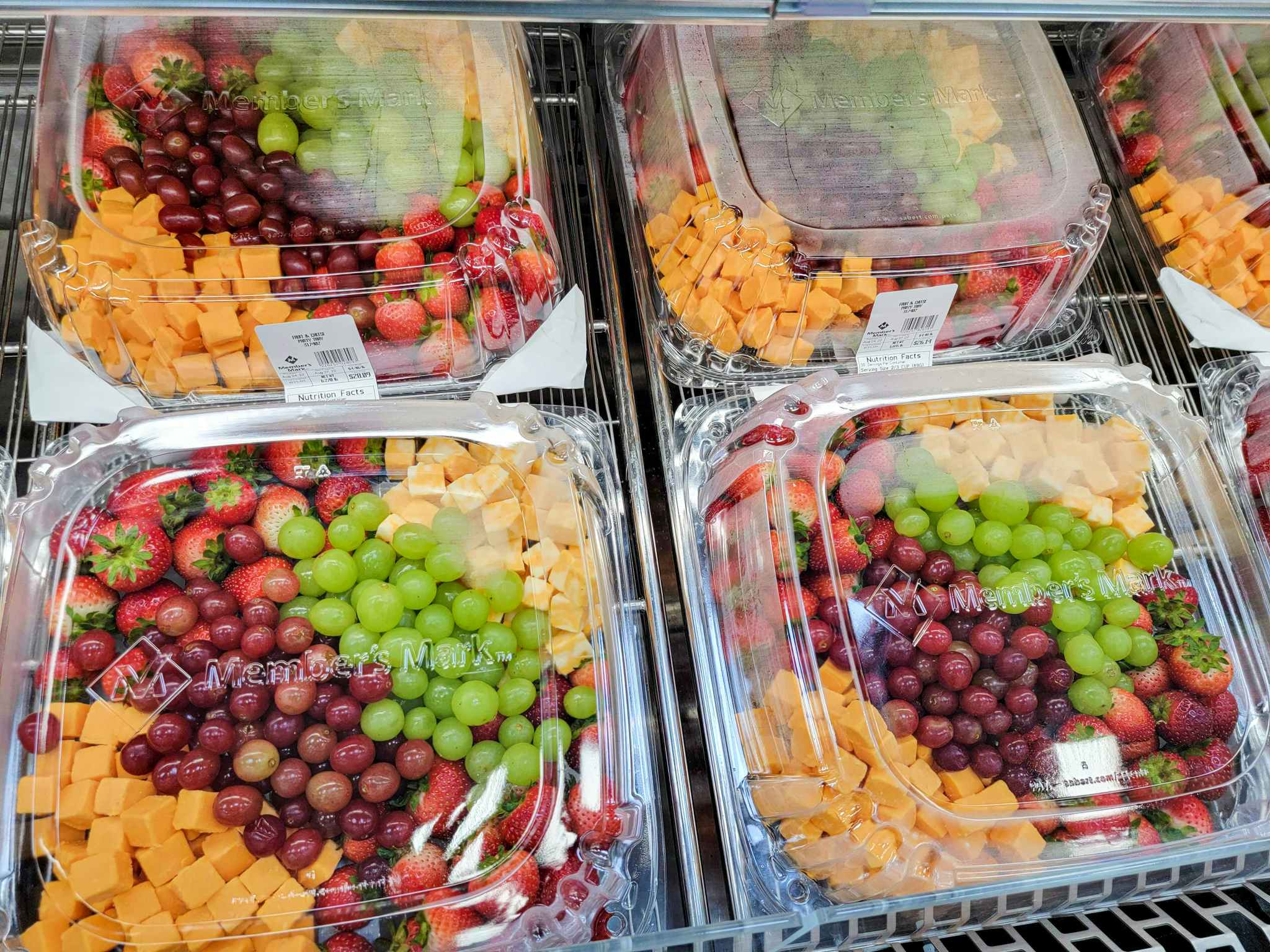 fruit trays with grapes, cheese, strawberries, etc