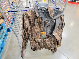 camo sherpa lined jacket hanging from a cart