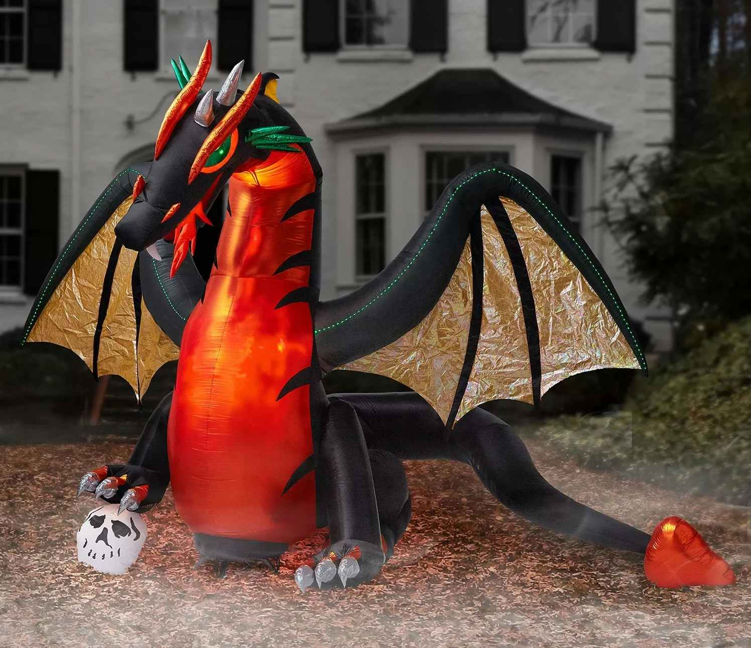 inflatable halloween dragon in front of a house
