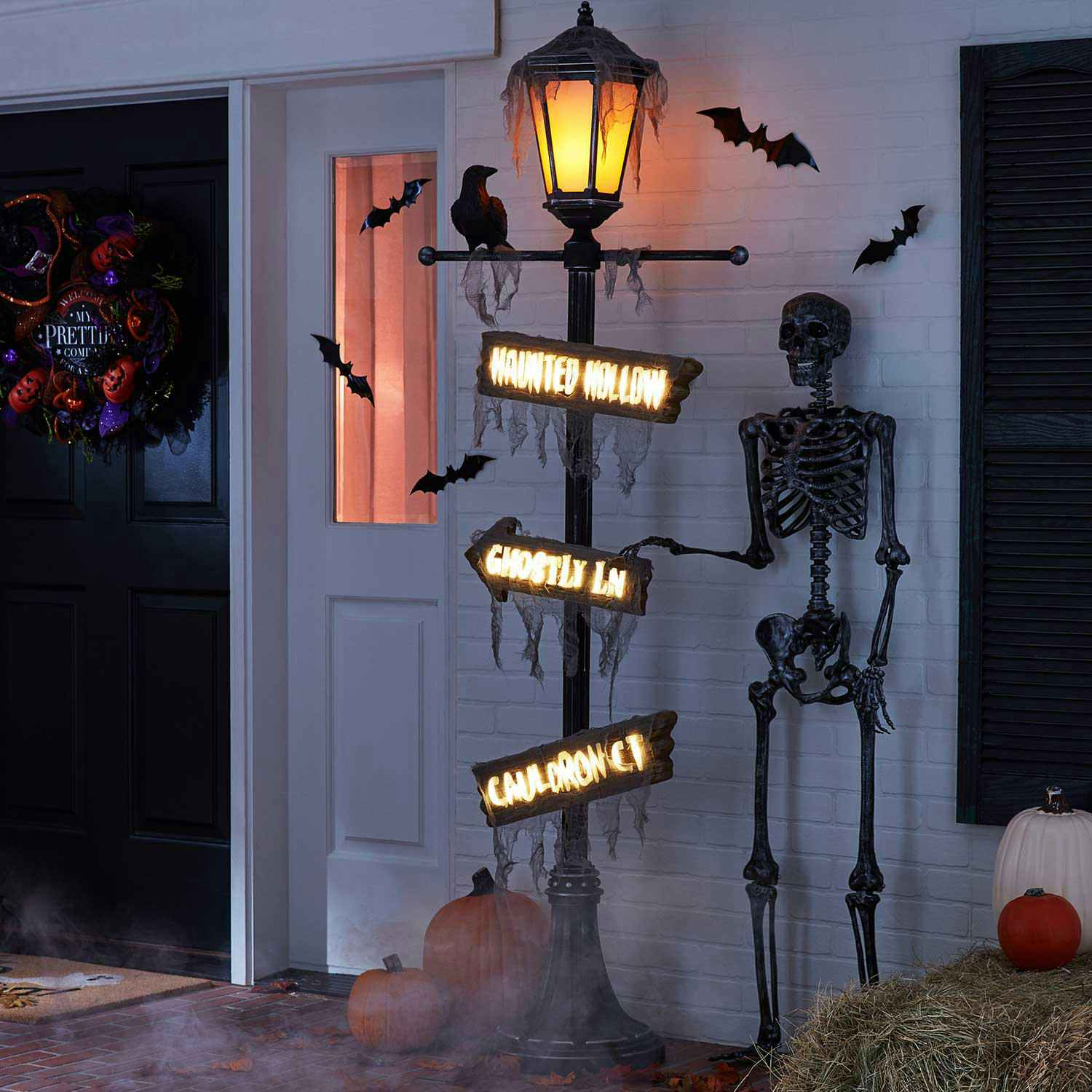 a lamp post decoration with halloween signs on it