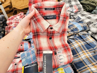 hand holding a red plaid mens lucky brand shirt