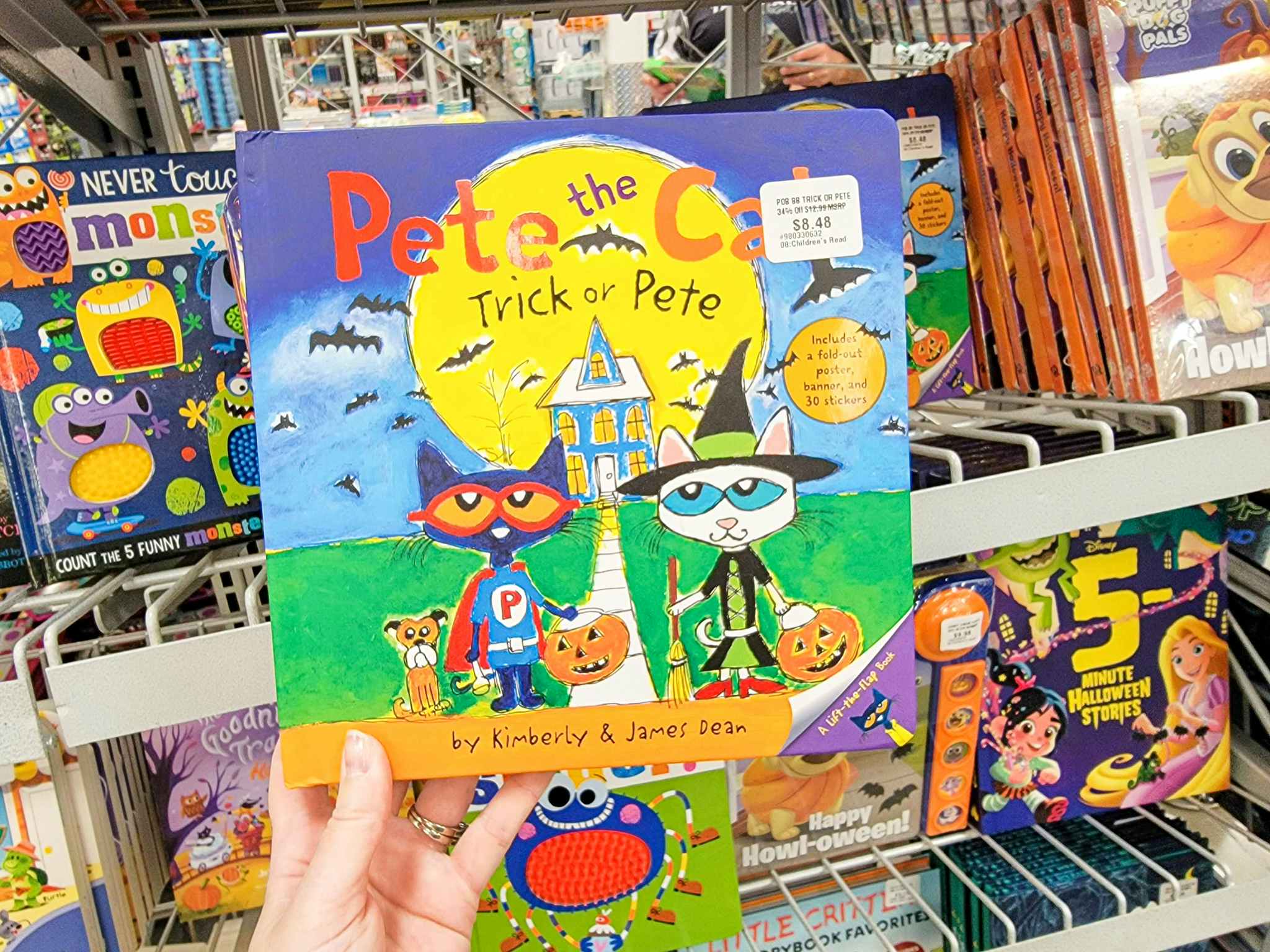 hand holding a pete the cat halloween book called trick or pete